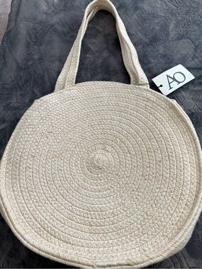 New!  Round eye ivory woven with gold thread tote bag